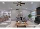 Staged living area with high ceilings, fireplace, lots of light, wood-look flooring, and open access to kitchen at 3708 Lorraine Ln, Las Vegas, NV 89120