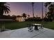 Lush backyard with verdant lawn, patio area, detached workshop and mature palm trees at 3708 Lorraine Ln, Las Vegas, NV 89120