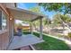 A covered patio offers outdoor living space and a stainless steel BBQ grill overlooking the fenced backyard at 4036 W Bird Man Ln, North Las Vegas, NV 89084