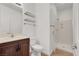 Modern bathroom with a glass shower, floating shelves, and vanity at 4036 W Bird Man Ln, North Las Vegas, NV 89084