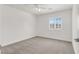 A bright bedroom offers a ceiling fan, and a window with white blinds at 4036 W Bird Man Ln, North Las Vegas, NV 89084