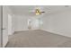 Large, bright bedroom featuring a ceiling fan, neutral carpet, and multiple entry points for convenience at 4036 W Bird Man Ln, North Las Vegas, NV 89084