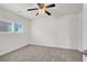 Bedroom features a ceiling fan and a window with white blinds at 4036 W Bird Man Ln, North Las Vegas, NV 89084