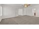 Comfortable bedroom featuring a ceiling fan, neutral carpet, and multiple doorways enhancing flow at 4036 W Bird Man Ln, North Las Vegas, NV 89084