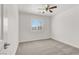 A bedroom features a ceiling fan and window with white blinds at 4036 W Bird Man Ln, North Las Vegas, NV 89084