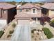 Exterior of a two-story house with a two-car garage and well-maintained desert landscaping at 4036 W Bird Man Ln, North Las Vegas, NV 89084