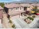 Two-story house with desert landscaping, a tile roof, and a two-car garage at 4036 W Bird Man Ln, North Las Vegas, NV 89084