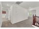 Upper hallway with carpet, laundry area, and access to other rooms; features clean white walls at 4036 W Bird Man Ln, North Las Vegas, NV 89084