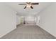 Expansive loft area featuring neutral carpeting and views of the wooden staircase and railing at 4036 W Bird Man Ln, North Las Vegas, NV 89084