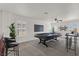 Virtually staged loft with a pool table, bar area, and plants, creating an inviting entertainment space at 4036 W Bird Man Ln, North Las Vegas, NV 89084