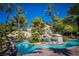 Community pool with a unique rock waterfall feature and palm trees at 4200 S Valley View Blvd # 1035, Las Vegas, NV 89103