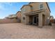 Spacious backyard featuring a covered patio, ample land for outdoor activities, and a privacy wall at 4348 Bayley Skye Ave, Las Vegas, NV 89141