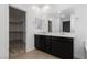 Bathroom featuring dual sinks and an adjacent walk-in closet at 4348 Bayley Skye Ave, Las Vegas, NV 89141