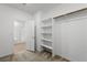 Bright bedroom featuring an open closet with shelving and a view of the shower through the doorway at 4348 Bayley Skye Ave, Las Vegas, NV 89141