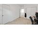 Neutral bedroom with a door, closet with mirrored doors, and adjacent room space at 4348 Bayley Skye Ave, Las Vegas, NV 89141