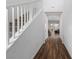Hallway with a staircase and wood-look flooring, leading to the living areas at 4348 Bayley Skye Ave, Las Vegas, NV 89141