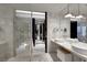 Luxurious marble bathroom featuring a glass-enclosed shower and dual vessel sinks at 4381 W Flamingo Rd # 3221, Las Vegas, NV 89103