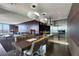 Open-concept kitchen with modern lighting, stainless steel appliances, and breakfast bar at 4381 W Flamingo Rd # 3221, Las Vegas, NV 89103
