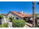 Well-maintained single-story home with a red tile roof, desert landscaping, and a charming covered patio area at 439 Columbia Ct, Boulder City, NV 89005