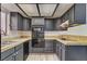 Well-maintained kitchen featuring dark cabinets, tile countertops, and modern appliances at 439 Columbia Ct, Boulder City, NV 89005