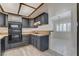 Well-equipped kitchen boasting dark cabinetry, tile countertops, and an open layout to the dining area at 439 Columbia Ct, Boulder City, NV 89005