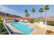Community pool with lounge chairs, palm trees, and mountain views, perfect for relaxation and recreation at 439 Columbia Ct, Boulder City, NV 89005