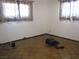 This bedroom features parquet floors, two windows, and neutral walls at 4950 Burnham Ave, Las Vegas, NV 89119