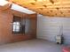 An open carport featuring exposed wooden beams, providing a rustic yet functional sheltered parking space at 4950 Burnham Ave, Las Vegas, NV 89119