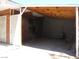 An open carport featuring exposed wooden beams, providing a rustic yet functional sheltered parking space at 4950 Burnham Ave, Las Vegas, NV 89119