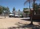 View of driveway area adjacent to the home, with mature trees offering shade on a sunny day at 4950 Burnham Ave, Las Vegas, NV 89119