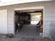 Spacious garage with high ceilings leading to second garage with door open to backyard at 4950 Burnham Ave, Las Vegas, NV 89119