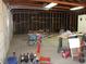 Spacious garage with high ceilings and unfinished walls featuring work tables and storage cabinets at 4950 Burnham Ave, Las Vegas, NV 89119