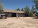 Rear view of the home with garage doors and a spacious lot at 4950 Burnham Ave, Las Vegas, NV 89119
