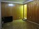 Spacious living room featuring wood paneling and parquet flooring at 4950 Burnham Ave, Las Vegas, NV 89119