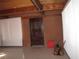 Living room featuring brick walls, and a vaulted ceiling with exposed beams at 4950 Burnham Ave, Las Vegas, NV 89119