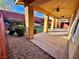 Backyard features low-maintenance desert landscaping and a covered patio at 5361 Candlespice Way, Las Vegas, NV 89135
