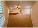 Large bonus room with built-in desk, shelving and ceiling fan at 5361 Candlespice Way, Las Vegas, NV 89135