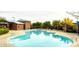 Community pool with clubhouse, outdoor lounge, and shaded seating areas at 5361 Candlespice Way, Las Vegas, NV 89135