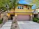Charming two-story home with a two-car garage, stone accents, and manicured landscaping offers great curb appeal at 5361 Candlespice Way, Las Vegas, NV 89135