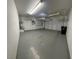 Spacious garage with epoxy floors, overhead storage and shelving at 5361 Candlespice Way, Las Vegas, NV 89135