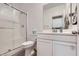 Bright bathroom featuring a glass shower door and contemporary white cabinets at 5606 Verde Valley Ct, North Las Vegas, NV 89081