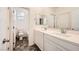 Bright bathroom with double sinks, modern vanity and dark tiled floors at 5606 Verde Valley Ct, North Las Vegas, NV 89081