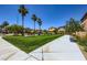Community park featuring a well maintained lawn, benches, sidewalks, and palm trees at 5606 Verde Valley Ct, North Las Vegas, NV 89081