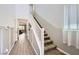 Inviting hallway with stairs, wood-look floors, and natural light creating a warm atmosphere at 5606 Verde Valley Ct, North Las Vegas, NV 89081