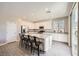 Modern kitchen with a large granite island, stainless appliances, and ample cabinet space at 5606 Verde Valley Ct, North Las Vegas, NV 89081