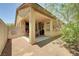 Exterior of home featuring covered patio and landscaped backyard with mature trees and desert landscaping at 5916 Sorto Lago St, North Las Vegas, NV 89081