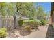 The backyard has desert landscaping and mature shade trees at 5916 Sorto Lago St, North Las Vegas, NV 89081