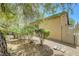 The backyard has desert landscaping and mature shade trees at 5916 Sorto Lago St, North Las Vegas, NV 89081