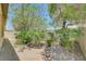 The backyard has desert landscaping and mature shade trees at 5916 Sorto Lago St, North Las Vegas, NV 89081