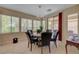 Bright dining area features large windows, a modern light fixture, and a round table with comfortable seating for six at 5916 Sorto Lago St, North Las Vegas, NV 89081